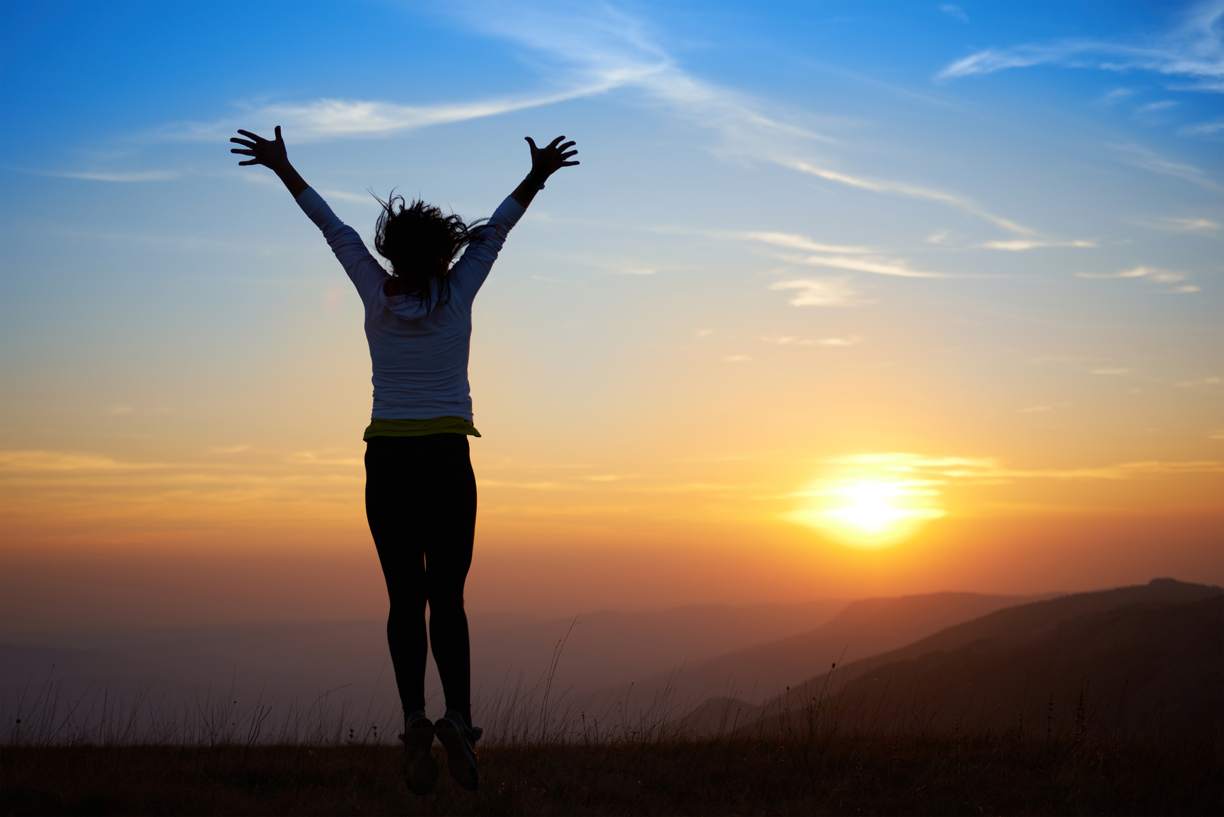 Silhouette of jumping young woman