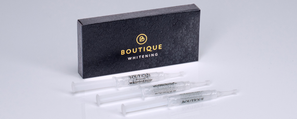 A close up image of the boutique teeth whitening product and syringes with logo